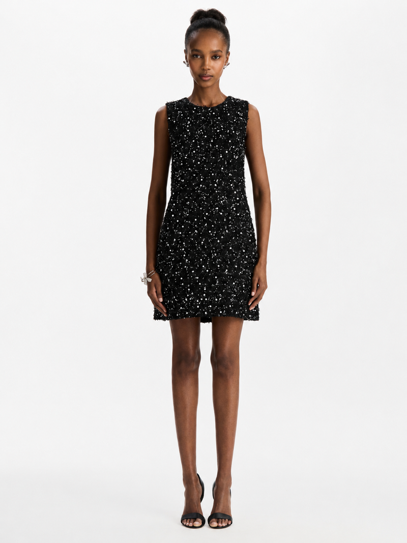 Model wearing black rhinestone mini dress from Oscar de la Renta. 