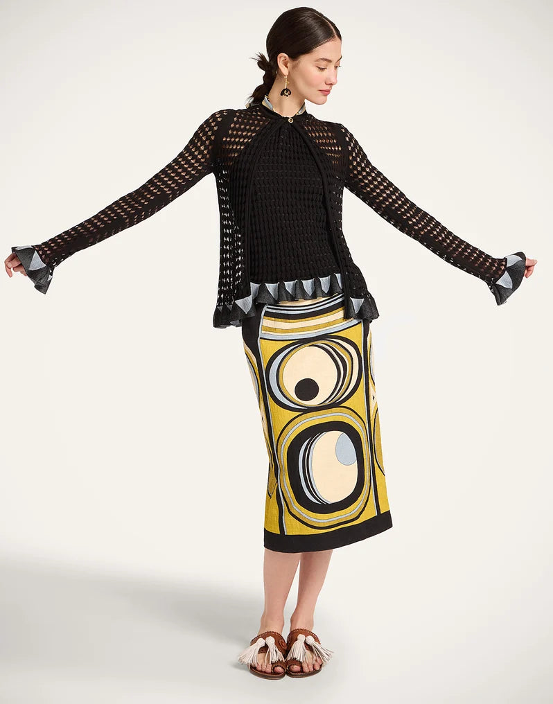 Woman wearing a black top and yellow patterned skirt from La Double J.